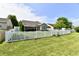 Spacious backyard with a white picket fence, lush lawn, and ample space for outdoor activities and enjoyment at 9022 Hosta Way, Camby, IN 46113