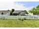 Expansive backyard showcasing a lush lawn, charming white fence, and inviting outdoor space for recreation at 9022 Hosta Way, Camby, IN 46113
