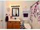 Charming bathroom with a wood vanity, updated fixtures, and a decorative shower curtain at 9022 Hosta Way, Camby, IN 46113
