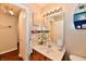 Cozy bathroom featuring a vanity with marble top, framed mirror and modern lighting at 9022 Hosta Way, Camby, IN 46113