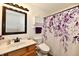 Bathroom features a modern vanity, toilet with bidet, and shower with a purple floral shower curtain at 9022 Hosta Way, Camby, IN 46113