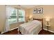 Sunny bedroom with large windows, wooden floors, and a neutral color scheme offers a cozy retreat at 9022 Hosta Way, Camby, IN 46113