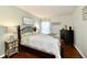 Well-lit bedroom featuring a wrought iron bed frame, dark dresser, and natural light at 9022 Hosta Way, Camby, IN 46113