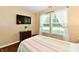 Bright bedroom with a flat screen tv, striped bedding and big windows creates a comfortable living space at 9022 Hosta Way, Camby, IN 46113
