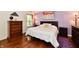 Comfortable bedroom features hardwood floors, a cozy bed, bedside tables, and modern artwork at 9022 Hosta Way, Camby, IN 46113