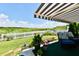 Inviting covered patio featuring comfortable seating, a fire pit, and picturesque views of the green landscape at 9022 Hosta Way, Camby, IN 46113