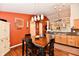 Light-filled dining area with modern lighting and a view of the adjacent kitchen at 9022 Hosta Way, Camby, IN 46113