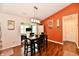 Inviting dining room featuring warm wood floors, an accent wall, and an open layout at 9022 Hosta Way, Camby, IN 46113