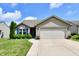 Charming home with blue shutters, well-manicured lawn, and attached two car garage at 9022 Hosta Way, Camby, IN 46113