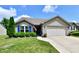 Charming home with blue shutters, well-manicured lawn, and attached two car garage at 9022 Hosta Way, Camby, IN 46113