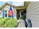 Inviting home entrance with an American flag, covered porch, and well-maintained landscaping at 9022 Hosta Way, Camby, IN 46113