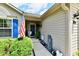 Welcoming front entrance featuring an American flag, tidy landscaping and a charming covered porch at 9022 Hosta Way, Camby, IN 46113