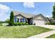 Charming single-story home featuring a well-manicured lawn, attached two-car garage and inviting curb appeal at 9022 Hosta Way, Camby, IN 46113
