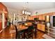 Spacious kitchen with stainless steel appliances, wood cabinetry, and a dining area at 9022 Hosta Way, Camby, IN 46113