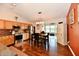Modern kitchen features stainless steel appliances, warm-toned cabinets, and adjacent dining area at 9022 Hosta Way, Camby, IN 46113