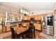 Spacious kitchen and dining area with stainless appliances, wood cabinets, and modern lighting at 9022 Hosta Way, Camby, IN 46113