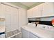 Functional laundry area with a washer, dryer, cabinets, and overhead storage at 9022 Hosta Way, Camby, IN 46113