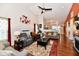 Spacious living room with high ceilings, hardwood floors, fireplace, and cozy furniture at 9022 Hosta Way, Camby, IN 46113