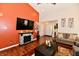 Comfortable living room showcasing a fireplace, television, hardwood floors, and neutral paint at 9022 Hosta Way, Camby, IN 46113