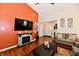Comfortable living room showcasing a fireplace, television, hardwood floors, and neutral paint at 9022 Hosta Way, Camby, IN 46113