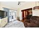 Cozy living room with a vaulted ceiling, wood floors, and access to the outdoors at 9022 Hosta Way, Camby, IN 46113