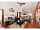 Spacious living room with vaulted ceilings, fan, hardwood floors, and abundant natural light at 9022 Hosta Way, Camby, IN 46113