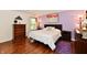 Comfortable main bedroom with hardwood floors, a decorative pillows, and natural light at 9022 Hosta Way, Camby, IN 46113