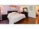 Spacious main bedroom featuring wood floors, a decorative mirror, and ensuite access at 9022 Hosta Way, Camby, IN 46113