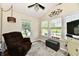 Cozy sunroom features lots of natural light with vaulted ceilings and a ceiling fan at 9022 Hosta Way, Camby, IN 46113