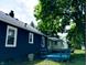 The exterior showcases a well-maintained backyard, offering a private outdoor retreat at 94 N Routiers Ave, Indianapolis, IN 46219