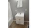 This bathroom features a sink with a vanity, mirror, and tub/shower at 94 N Routiers Ave, Indianapolis, IN 46219