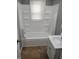 Bathroom with tub, sink and window with blinds at 94 N Routiers Ave, Indianapolis, IN 46219