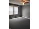 Bedroom with gray walls, black floors, ceiling fan, and bright natural light from two windows at 94 N Routiers Ave, Indianapolis, IN 46219