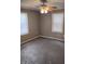 This bedroom has neutral walls, a ceiling fan, carpet, and windows with blinds at 94 N Routiers Ave, Indianapolis, IN 46219