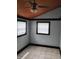 Neutral bedroom featuring tile floor, ceiling fan, two windows and dark painted trim at 94 N Routiers Ave, Indianapolis, IN 46219