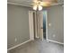 This bedroom has neutral walls, a ceiling fan, carpet, and two open doors at 94 N Routiers Ave, Indianapolis, IN 46219