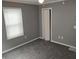 Bedroom featuring neutral paint, carpet, window with blinds and closet at 94 N Routiers Ave, Indianapolis, IN 46219