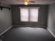 This is a bedroom with a window with blinds and neutral paint at 94 N Routiers Ave, Indianapolis, IN 46219