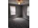 This bedroom has neutral paint, ceiling fan and two windows with blinds at 94 N Routiers Ave, Indianapolis, IN 46219