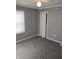 Bedroom featuring neutral paint, carpet, window with blinds and closet at 94 N Routiers Ave, Indianapolis, IN 46219