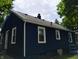 Image showcases the home's rear elevation with white trim around the windows at 94 N Routiers Ave, Indianapolis, IN 46219