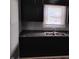 Kitchen features dark cabinetry, laminate countertops, and a stainless steel sink under a window at 94 N Routiers Ave, Indianapolis, IN 46219