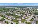 Panoramic aerial view of a community featuring tree-lined streets, well-kept homes, and manicured lawns on a sunny day at 9724 Brooks Dr, Fishers, IN 46055