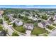 Aerial view of a neighborhood showcasing well-maintained homes with mature trees, landscaping, and community streets at 9724 Brooks Dr, Fishers, IN 46055