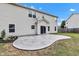 A backyard showcases a custom stamped concrete patio extending from the house, surrounded by a neatly maintained lawn at 9724 Brooks Dr, Fishers, IN 46055