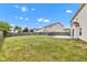 Lush backyard featuring a well-kept lawn, wood fence, and a stamped concrete patio, creating a serene outdoor space at 9724 Brooks Dr, Fishers, IN 46055