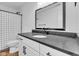 Stylish bathroom featuring a modern vanity with a dark countertop, sleek hardware and a decorative black and white shower curtain at 9724 Brooks Dr, Fishers, IN 46055