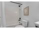 Clean bathroom featuring a tub with black fixtures, toilet, and neutral wall art at 9724 Brooks Dr, Fishers, IN 46055