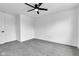 Bedroom featuring plush carpeting, neutral walls, and a ceiling fan plus an adjacent door at 9724 Brooks Dr, Fishers, IN 46055