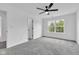 Bedroom featuring plush carpeting, a ceiling fan, and two doors - one to another room and one to a closet at 9724 Brooks Dr, Fishers, IN 46055
